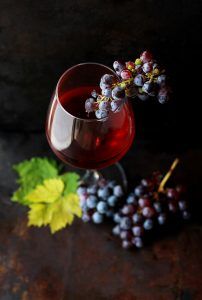 a glass of zinfandel wine with grapes