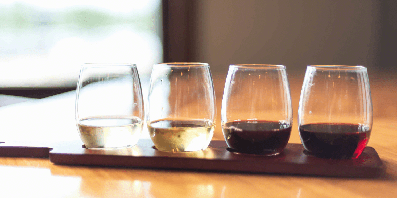 a flight of different types of wine, wine sampler