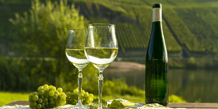 two wine glasses and a bottle of riesling wine