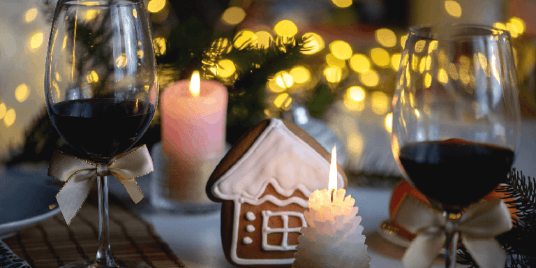 christmas dinnerware including wine glasses filled with red wine