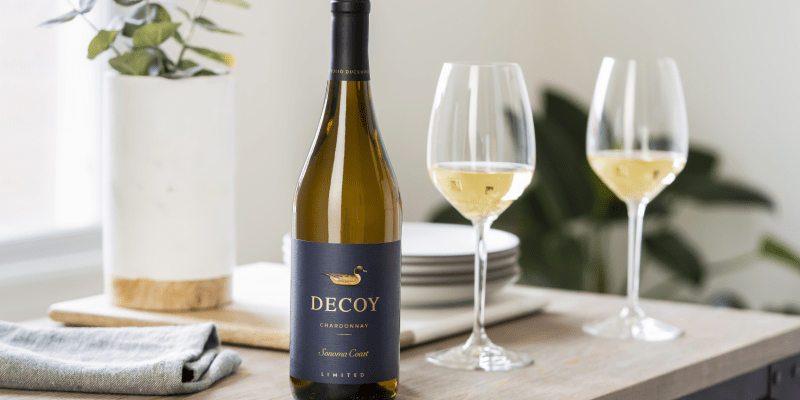 a bottle of decoy wine chardonnay next to wine glasses
