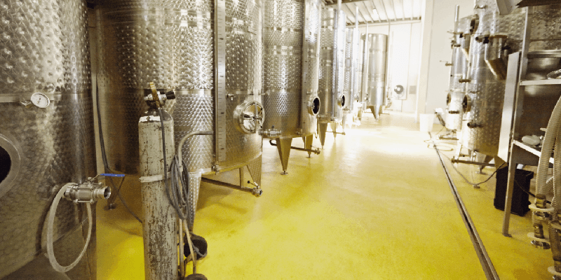 wine fermenting in stainless steel containers