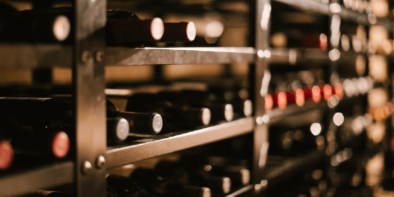 wine bottles laying on a wooden wine rack